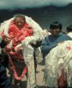 Ed Hillary covered in silk scarves or Karta, a mark of respect from the Sherpa people. c 1972